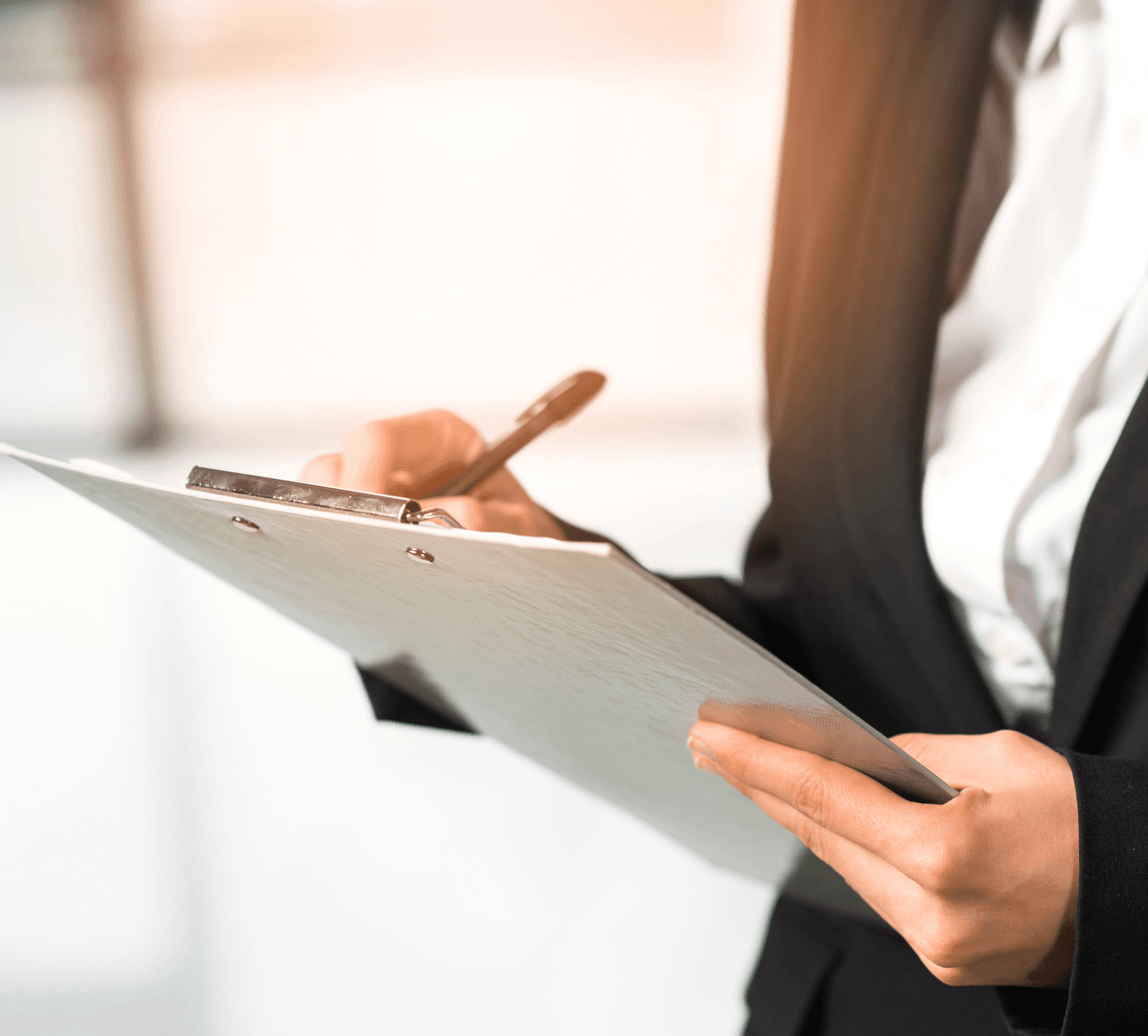 close-up-woman-writing-clipboard-with-pen